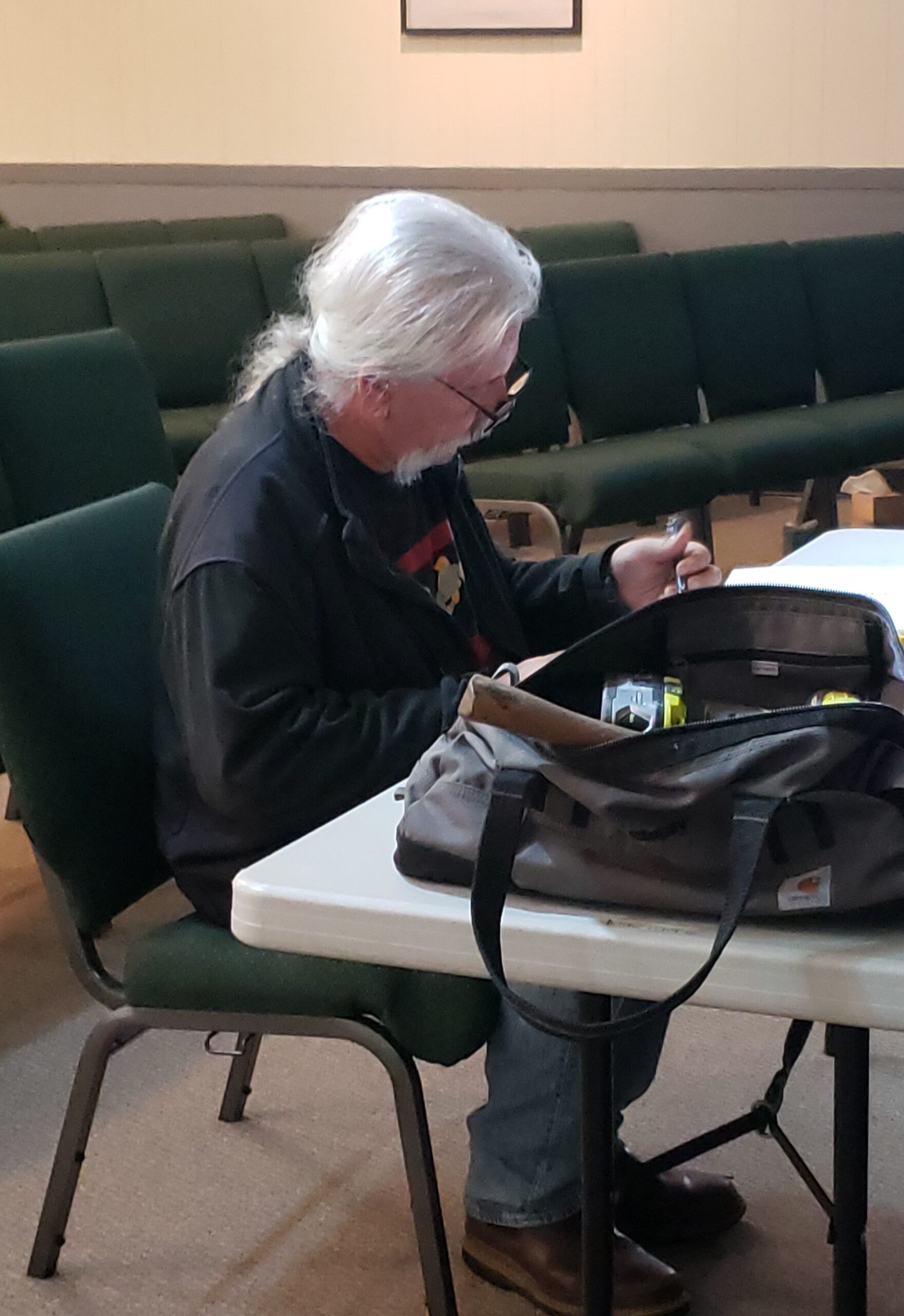 Doug sitting at a table working on facility assessment paperwork.
